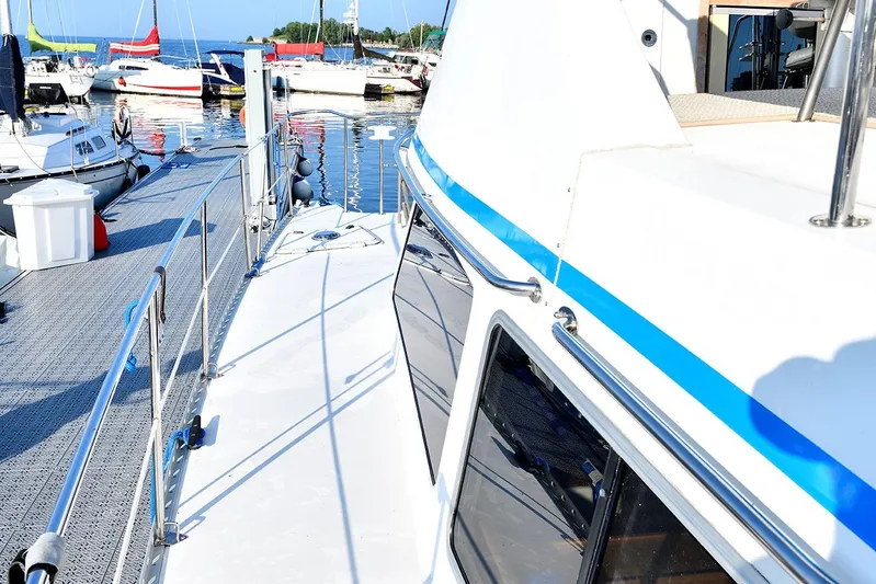 Two Buoys Yacht Photos Pics 2002 PDQ 32 Power Catamaran docked at marina with other boats.