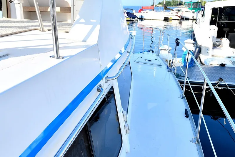 Two Buoys Yacht Photos Pics 2002 PDQ 32 Power Catamaran docked at marina, showcasing sleek deck design.