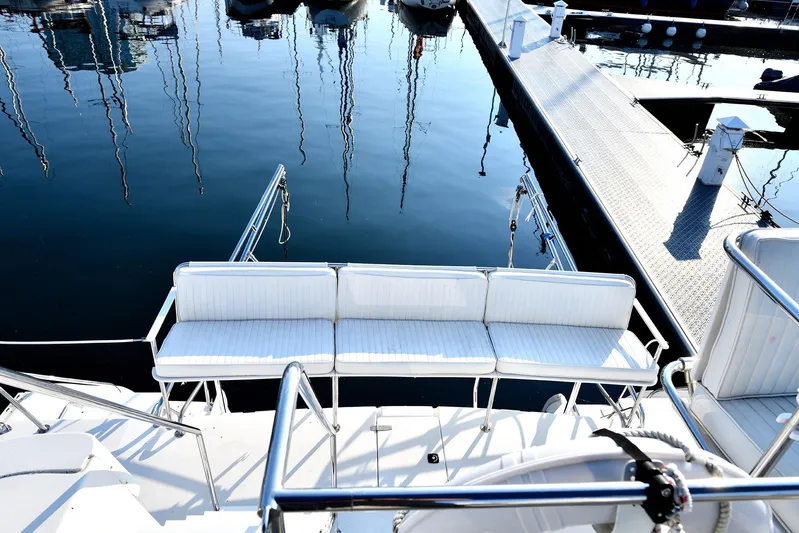 Two Buoys Yacht Photos Pics 2002 PDQ 32 Power Catamaran with white seating at marina dock.