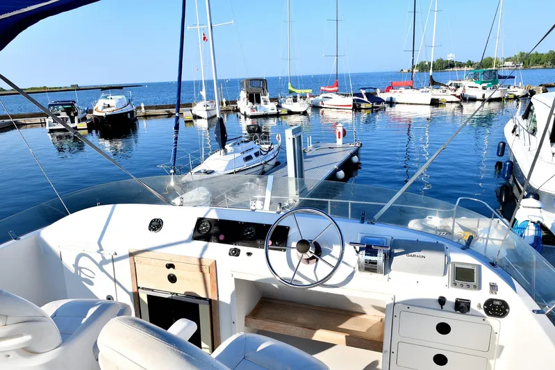 Two Buoys Yacht Photos Pics Cockpit view of 2002 PDQ 32 Power Catamaran docked at a marina with sailboats.