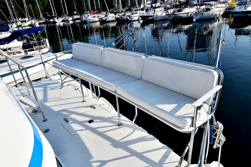 Two Buoys Yacht Photos Pics 2002 PDQ 32 Power Catamaran with white seating, docked in a marina.