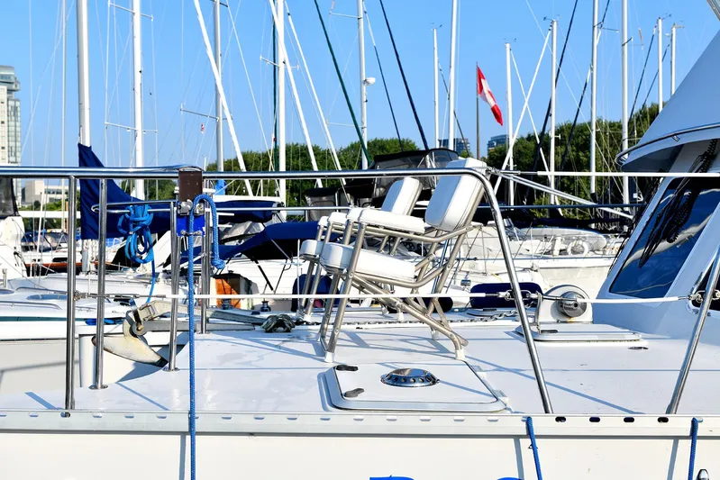 Two Buoys Yacht Photos Pics 2002 PDQ 32 Power Catamaran docked in marina with Canadian flag in background.