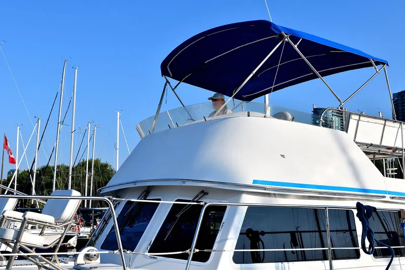 Two Buoys Yacht Photos Pics 2002 PDQ 32 Power Catamaran with blue canopy docked in marina.