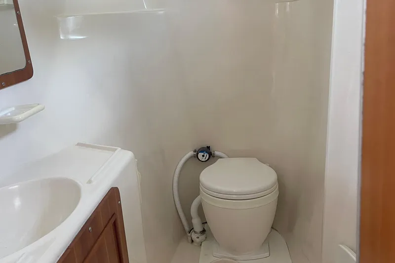 Two Buoys Yacht Photos Pics Bathroom interior of 2002 PDQ 32 Power Catamaran with toilet and sink.