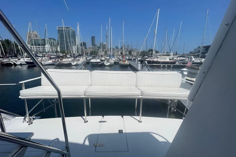 Two Buoys Yacht Photos Pics 2002 PDQ 32 Power Catamaran at marina, city skyline in background, sunny day.