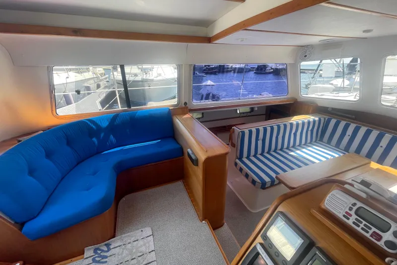 Two Buoys Yacht Photos Pics Interior of 2002 PDQ 32 Power Catamaran with blue and striped seating.