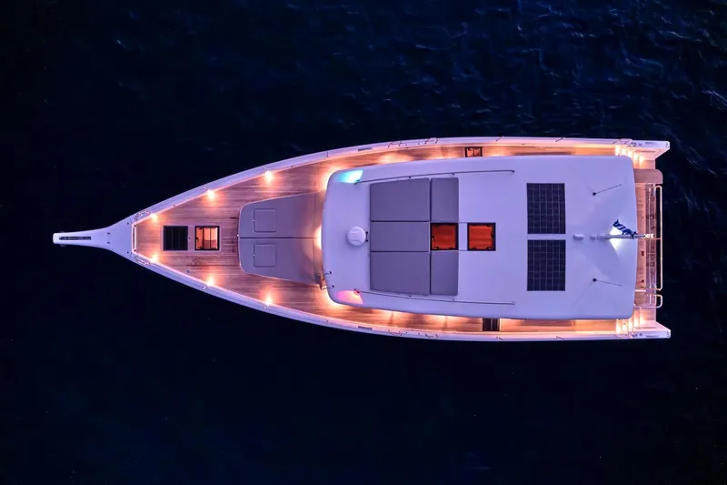  Yacht Photos Pics Aerial view of 2026 Omikron Yachts OT-60, illuminated deck at night.