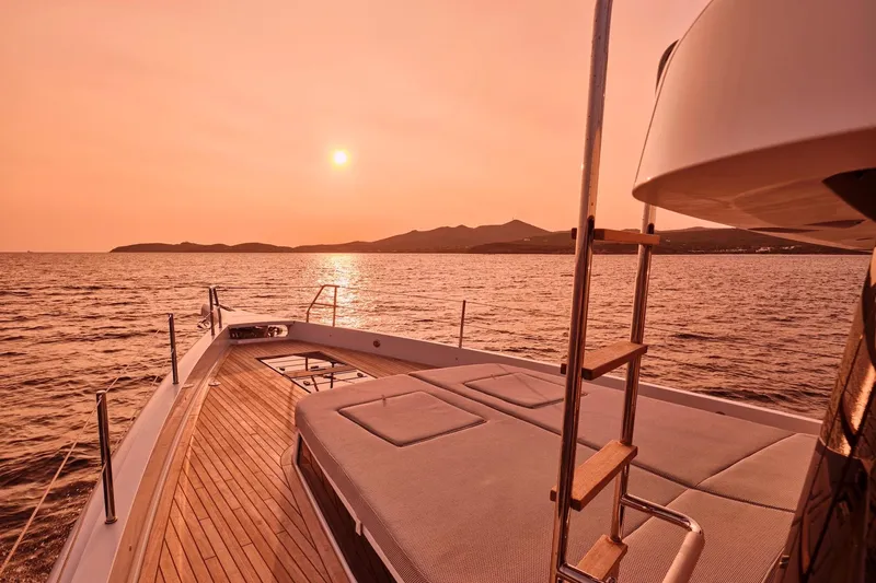  Yacht Photos Pics 2026 Omikron Yachts OT-60 at sunset, featuring a luxurious deck and serene ocean view.