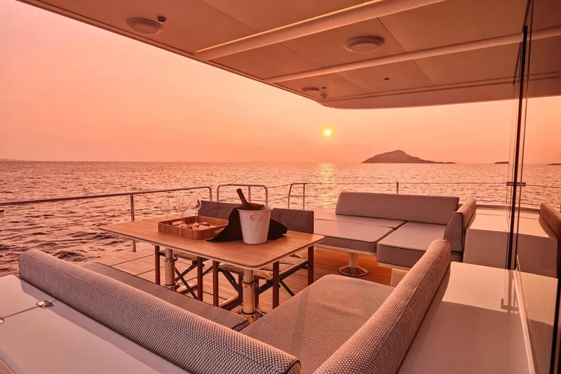  Yacht Photos Pics Luxurious Omikron Yachts OT-60, 2026 model, with sunset ocean view and elegant deck seating.
