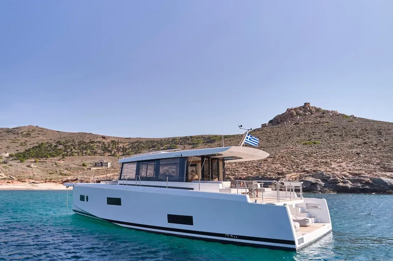  Yacht Photos Pics 2026 Omikron Yachts OT-60 in serene coastal waters, showcasing sleek design and luxury.