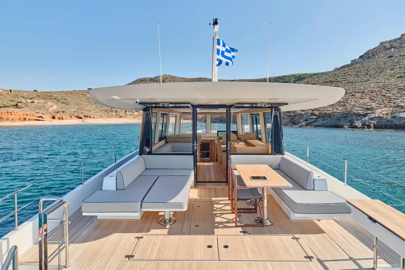  Yacht Photos Pics Luxurious 2026 Omikron Yachts OT-60 on serene waters, featuring spacious deck and elegant seating.