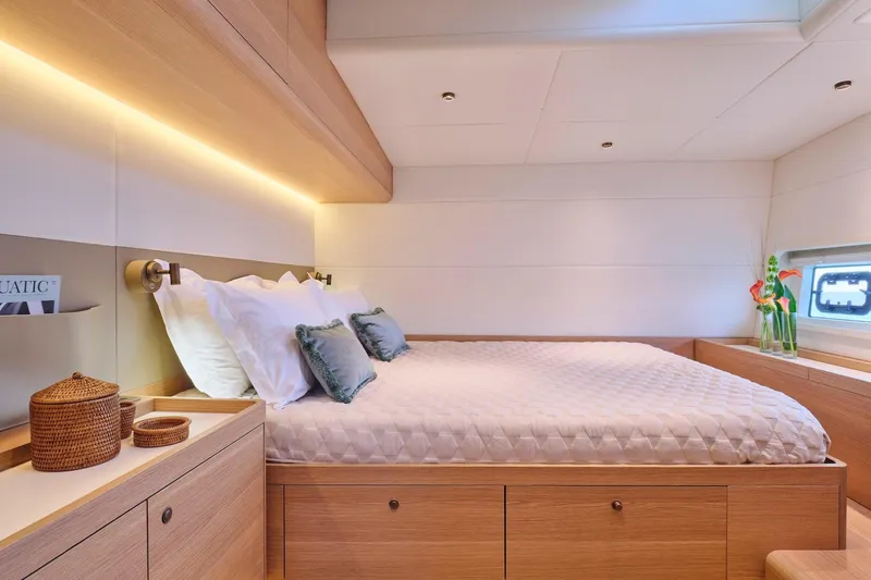  Yacht Photos Pics Luxurious bedroom interior of 2026 Omikron Yachts OT-60, featuring elegant wood finishes and ambient lighting.