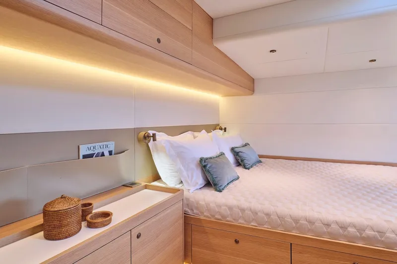  Yacht Photos Pics Luxurious bedroom interior of 2026 Omikron Yachts OT-60, featuring elegant wood finishes and ambient lighting.