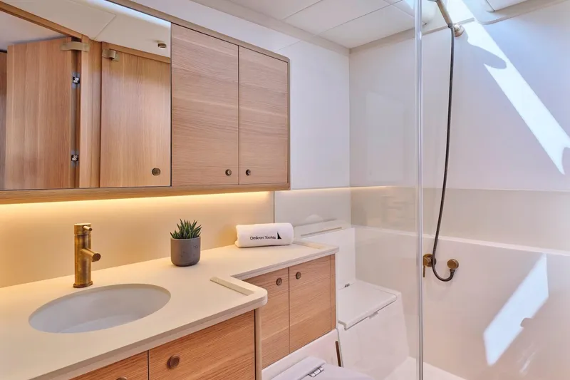  Yacht Photos Pics Luxurious bathroom in 2026 Omikron Yachts OT-60, featuring modern fixtures and elegant wood cabinetry.