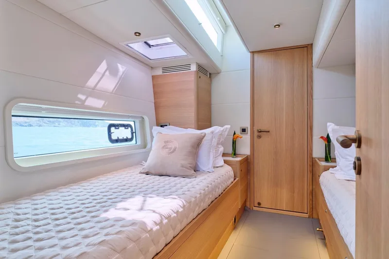  Yacht Photos Pics Luxurious cabin interior of 2026 Omikron Yachts OT-60 with twin beds and modern design.