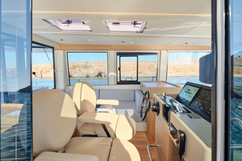  Yacht Photos Pics Interior of 2026 Omikron Yachts OT-60, featuring modern helm and luxurious seating.