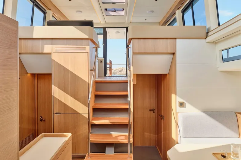  Yacht Photos Pics Luxurious interior of 2026 Omikron Yachts OT-60, featuring modern wood finishes and ample natural light.