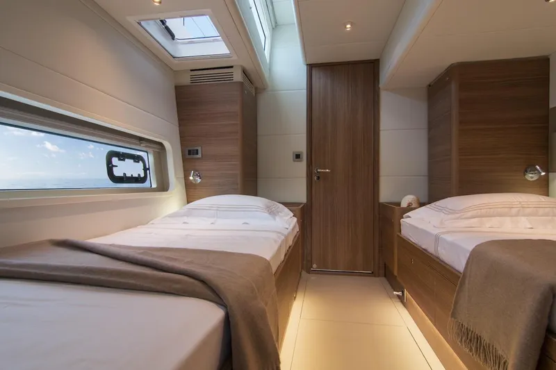  Yacht Photos Pics Luxurious twin cabin interior of 2026 Omikron Yachts OT-60, featuring modern design and ocean view.