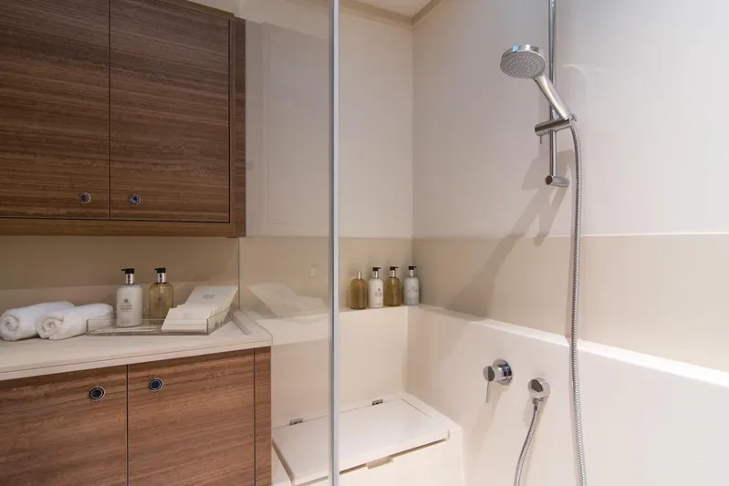  Yacht Photos Pics Luxurious bathroom in 2026 Omikron Yachts OT-60, featuring modern shower and wooden cabinetry.