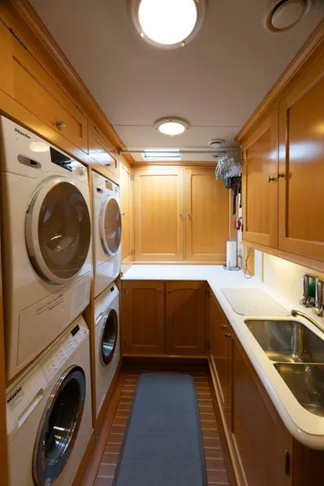 Catalina Yacht Photos Pics Laundry room in 2001 Vitters Aft Cockpit yacht with washer, dryer, and wooden cabinetry.