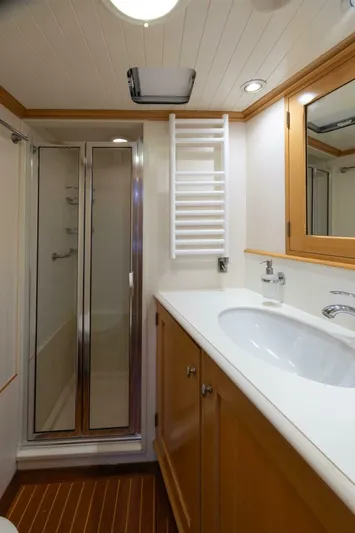 Catalina Yacht Photos Pics Luxurious bathroom in 2001 Vitters Aft Cockpit yacht with modern fixtures and wooden cabinetry.