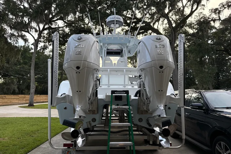  Yacht Photos Pics 2025 Freeman 28 boat with dual Yamaha V6 300 engines, parked outdoors.