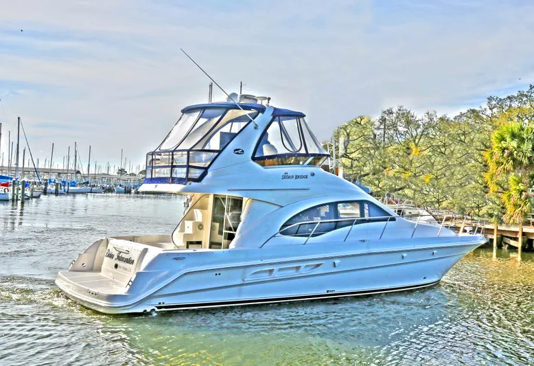 Devine Intervention Yacht Photos Pics 2007 Sea Ray 44 Sedan Bridge yacht on calm water near marina.