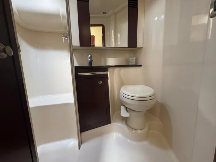 Devine Intervention Yacht Photos Pics 2007 Sea Ray 44 Sedan Bridge bathroom with toilet, sink, and mirror.