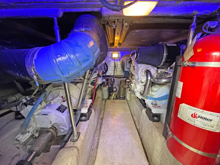 Devine Intervention Yacht Photos Pics Engine room of 2007 Sea Ray 44 Sedan Bridge with visible machinery and fire extinguisher.