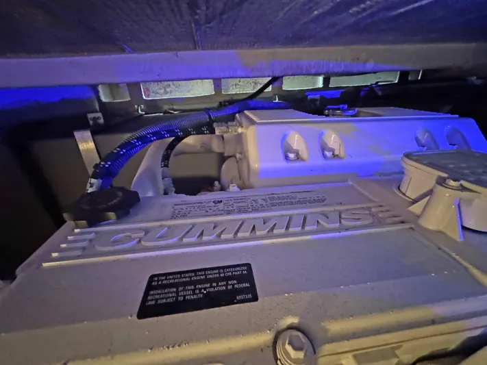 Devine Intervention Yacht Photos Pics Cummins engine in 2007 Sea Ray 44 Sedan Bridge under blue lighting.