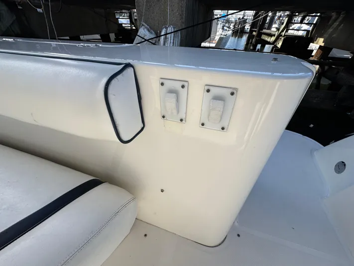 Devine Intervention Yacht Photos Pics 2007 Sea Ray 44 Sedan Bridge interior with white seating and control switches.