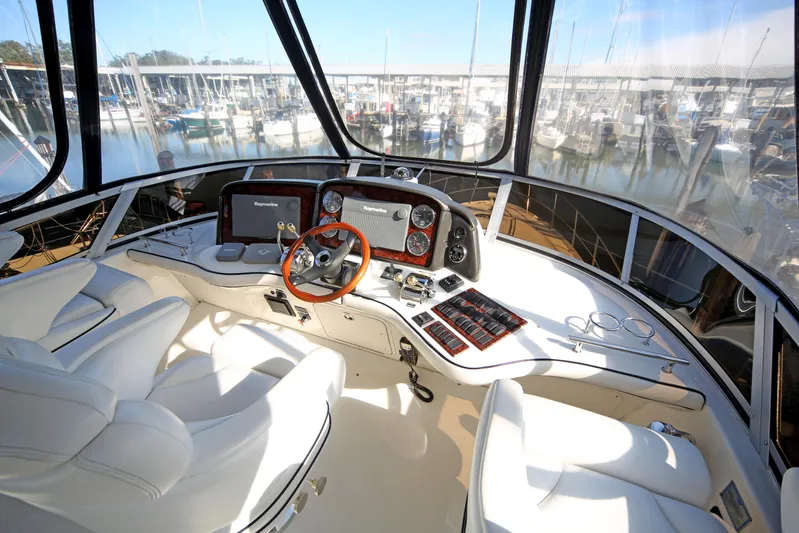 Devine Intervention Yacht Photos Pics 2007 Sea Ray 44 Sedan Bridge helm with modern controls and panoramic marina view.