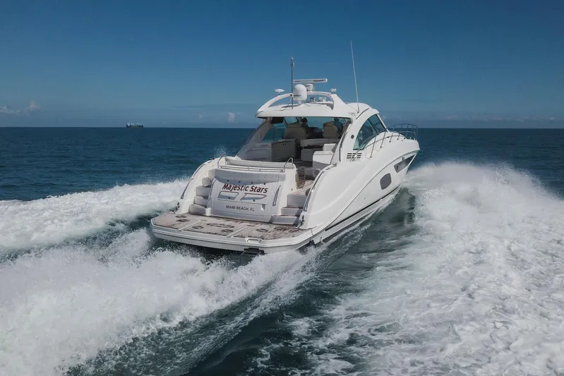  Yacht Photos Pics 2012 Sea Ray 580 Sundancer yacht cruising on open ocean waters.