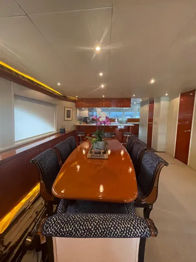  Yacht Photos Pics Luxurious dining area on 2000 Cheoy Lee CUSTOM 92 yacht with elegant wood table and plush seating.