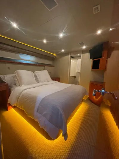  Yacht Photos Pics Luxurious bedroom on 2000 Cheoy Lee CUSTOM 92 yacht with ambient lighting and modern amenities.