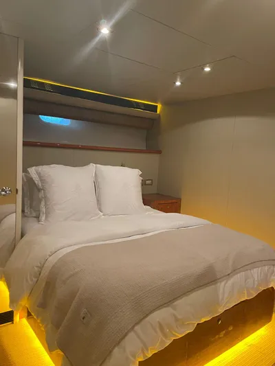  Yacht Photos Pics Luxurious bedroom in 2000 Cheoy Lee CUSTOM 92 yacht with modern lighting and cozy bedding.