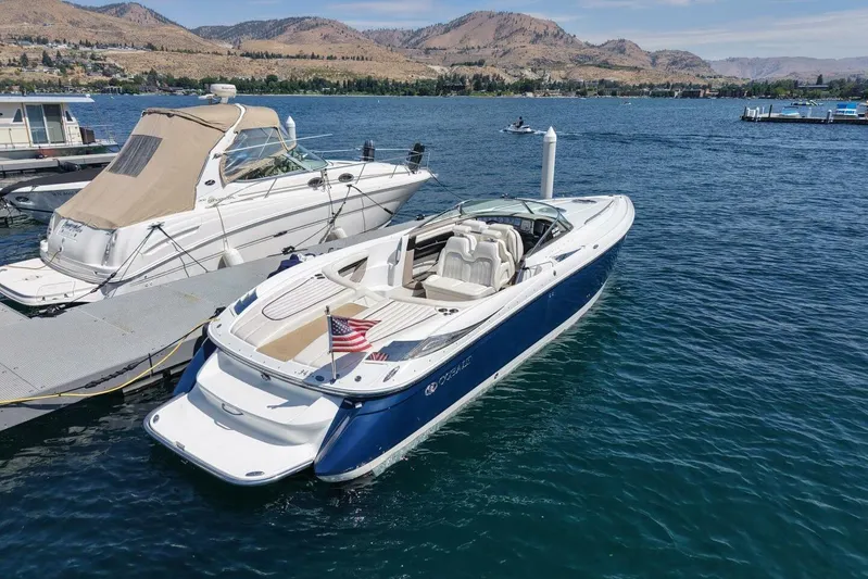  Yacht Photos Pics 2005 Cobalt 343 boat docked on a scenic lake with mountains in the background.