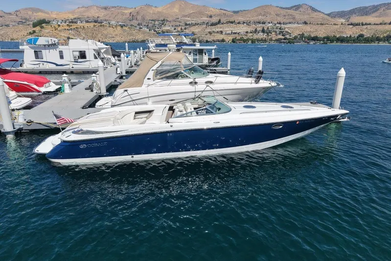  Yacht Photos Pics 2005 Cobalt 343 boat docked on a lake with scenic mountain backdrop.