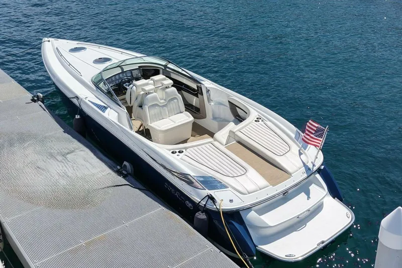  Yacht Photos Pics 2005 Cobalt 343 boat docked on clear blue water with American flag.