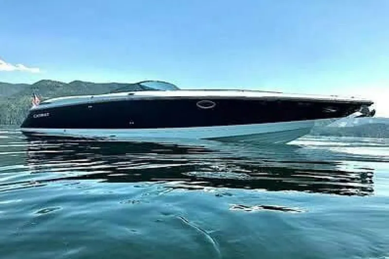  Yacht Photos Pics 2005 Cobalt 343 boat cruising on a calm lake with scenic mountain backdrop.