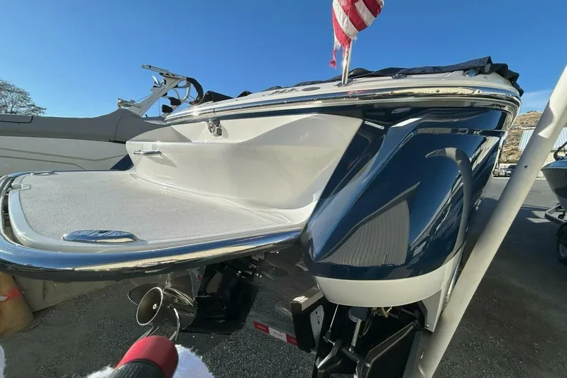  Yacht Photos Pics 2005 Cobalt 343 boat with American flag, sleek design, and shiny exterior on a sunny day.