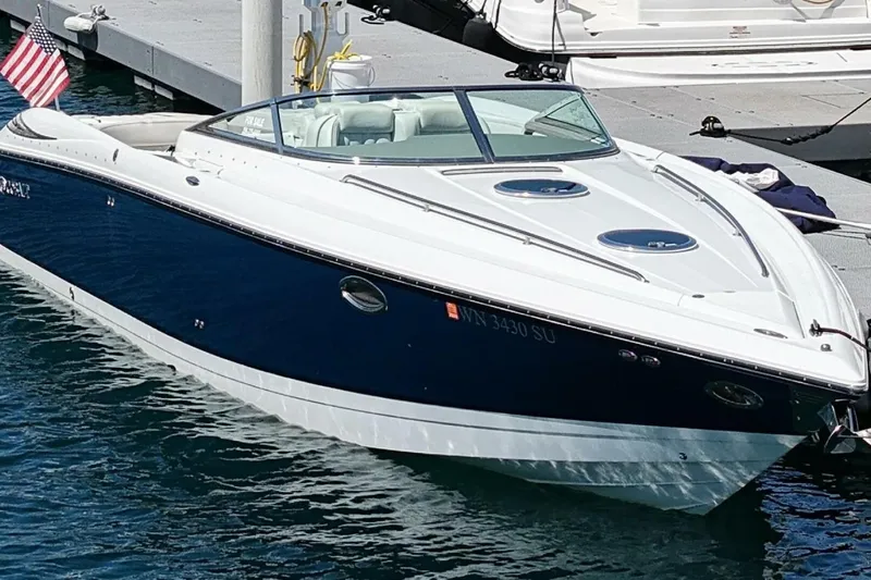  Yacht Photos Pics 2005 Cobalt 343 boat docked, featuring sleek design and American flag.