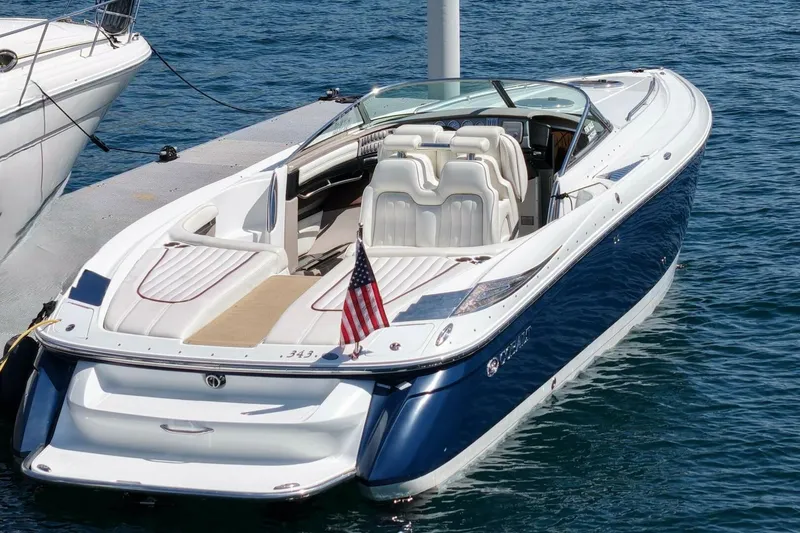  Yacht Photos Pics 2005 Cobalt 343 boat docked on water, featuring sleek design and American flag.