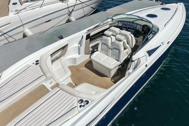  Yacht Photos Pics 2005 Cobalt 343 boat with white interior, docked on clear water.