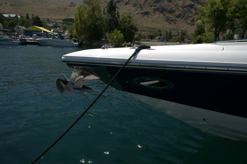  Yacht Photos Pics 2005 Cobalt 343 boat anchored on a scenic lake with mountainous backdrop.