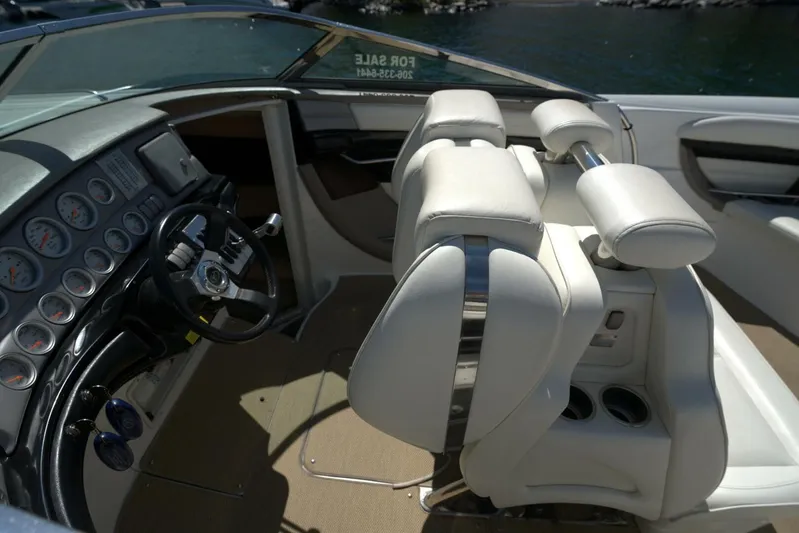  Yacht Photos Pics 2005 Cobalt 343 boat interior with steering wheel and white leather seats.