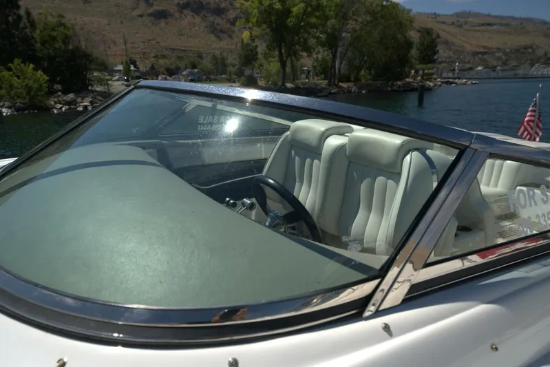  Yacht Photos Pics 2005 Cobalt 343 boat interior with white seats, docked by a scenic lake.