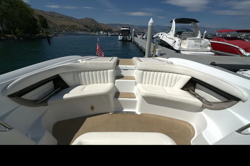  Yacht Photos Pics 2005 Cobalt 343 boat interior with white seating, docked at a scenic marina.