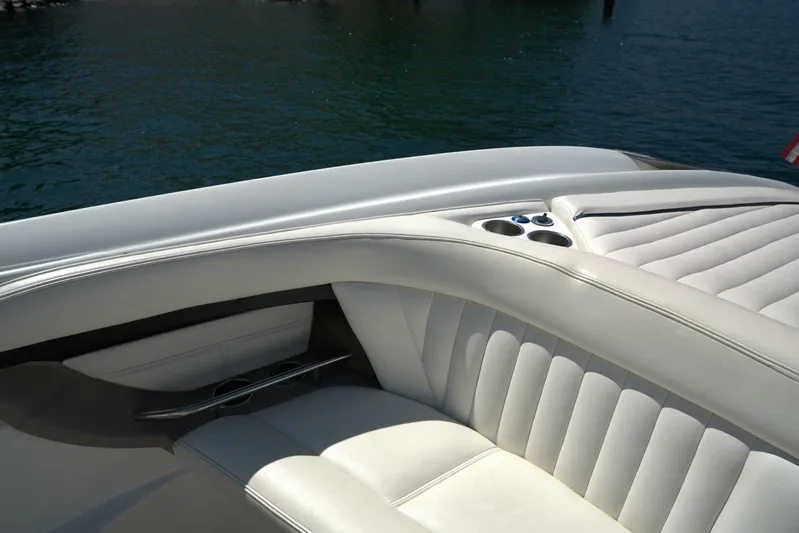  Yacht Photos Pics Luxury seating on a 2005 Cobalt 343 boat with cup holders, near water.