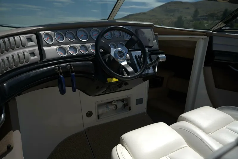  Yacht Photos Pics Interior of a 2005 Cobalt 343 boat showing steering wheel and dashboard gauges.